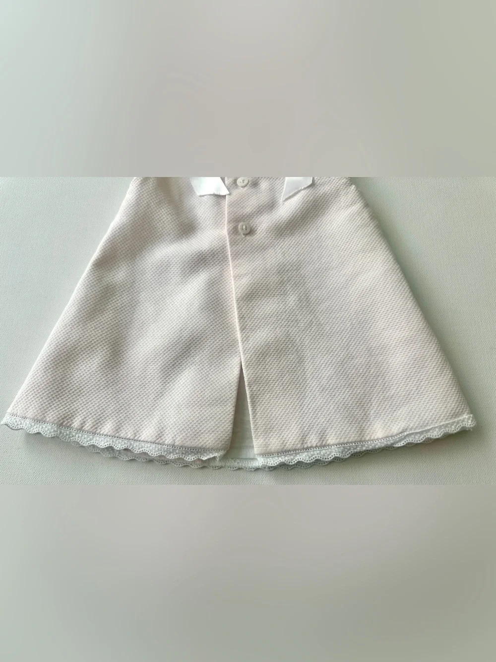 Dulces girl’s pique dress is classic Spanish-style heirloom garment.  Size 0-3M.